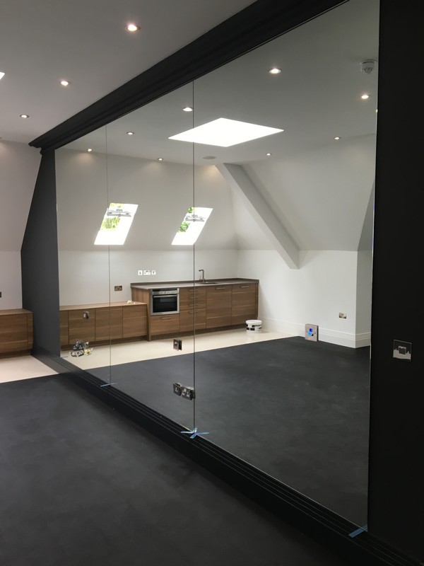 Frameless glass partition in loft conversion by Harpenden glaziers