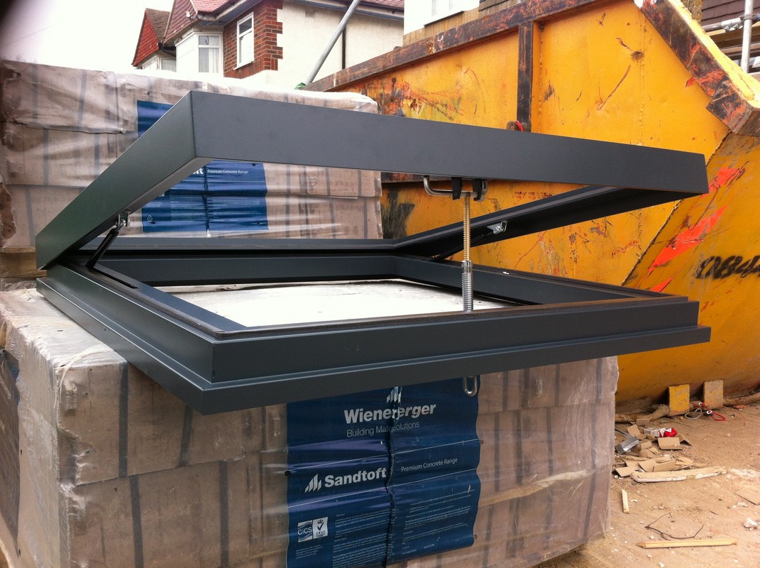 Opening flat roof skylight in anthracite grey installed in Harpenden